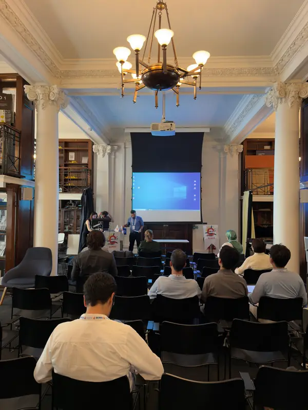The audience facing the screen between two columns.