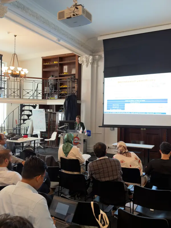 A presentation in progress, seen from the back of the hall.